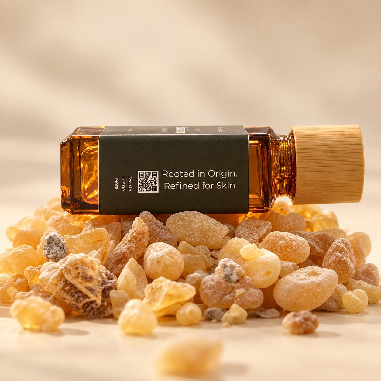An amber MEROË bottle resting on frankincense resin